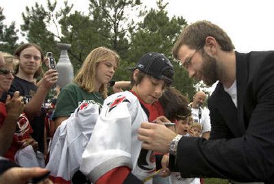
Carolina fans greet forward Hurricanes Erik Cole, who has missed the Stanley Cup finals with a neck injury. 
 (Associated Press / The Spokesman-Review)