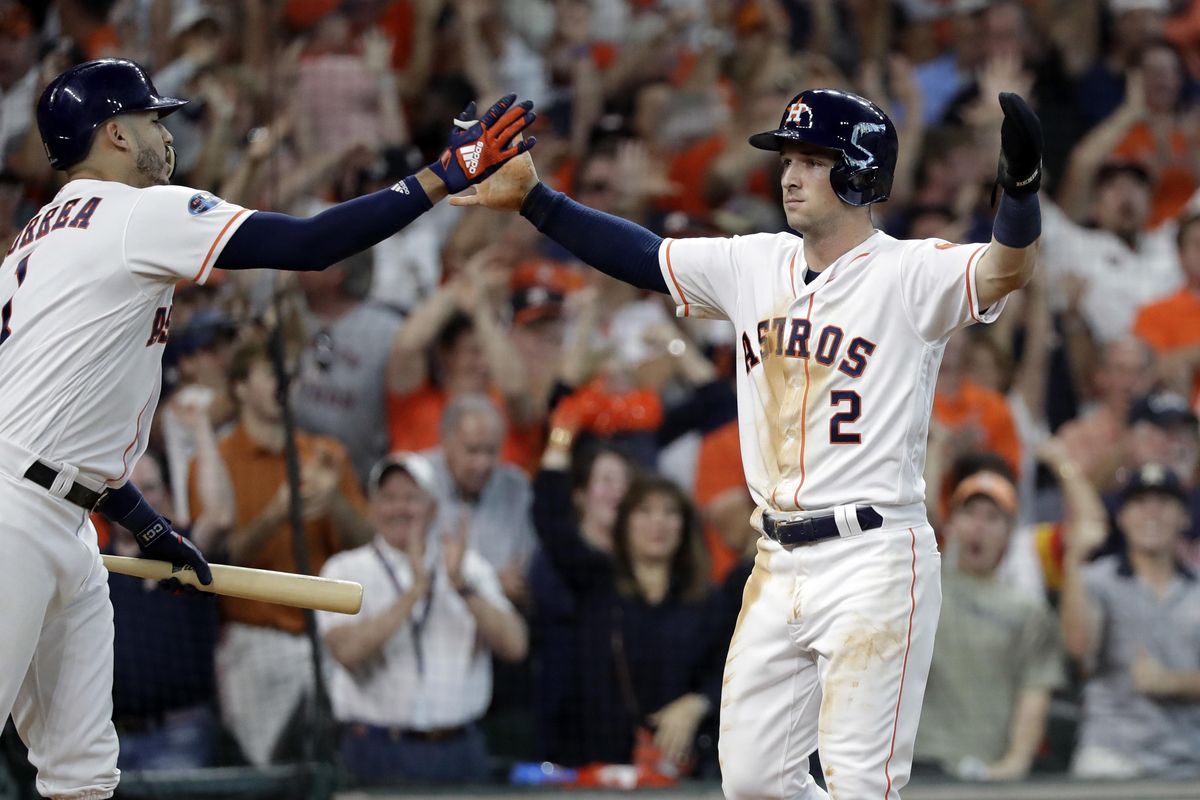 Houston’s Alex Bregman (2) celebrates with teammate Carlos Correa  after he scored against the Cleveland Indians during the sixth inning Saturday in Houston. (David J. Phillip / AP)