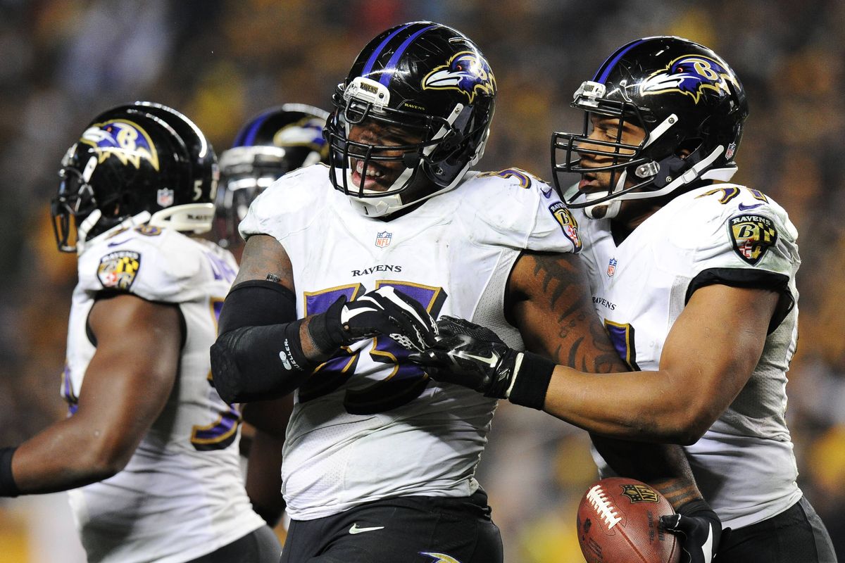 Baltimore linebacker Terrell Suggs, center, celebrates after intercepting a pass in the fourth quarter in Pittsburgh. (Associated Press)