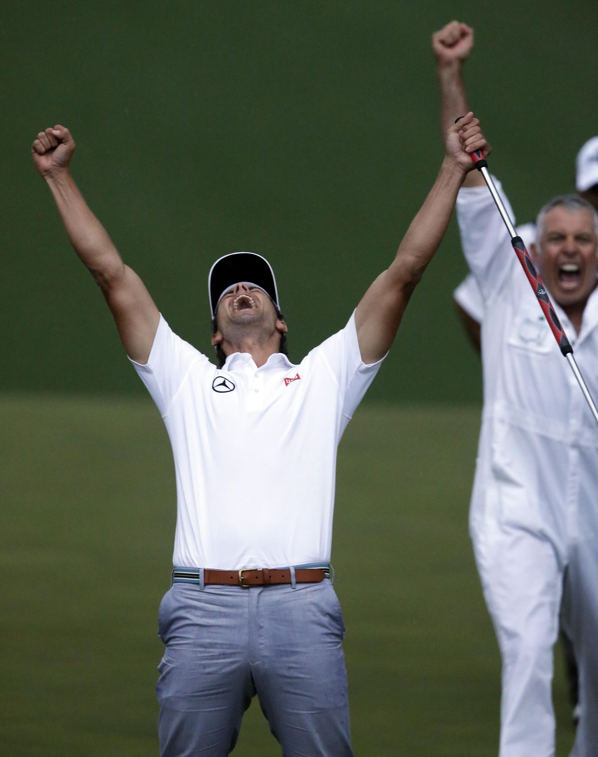 In this April 14, 2013 file photo, Adam Scott, of Australia, celebrates with caddie Steve Williams after making a birdie putt on the second playoff hole to win the Masters golf tournament in Augusta, Ga. (David Goldman / AP)