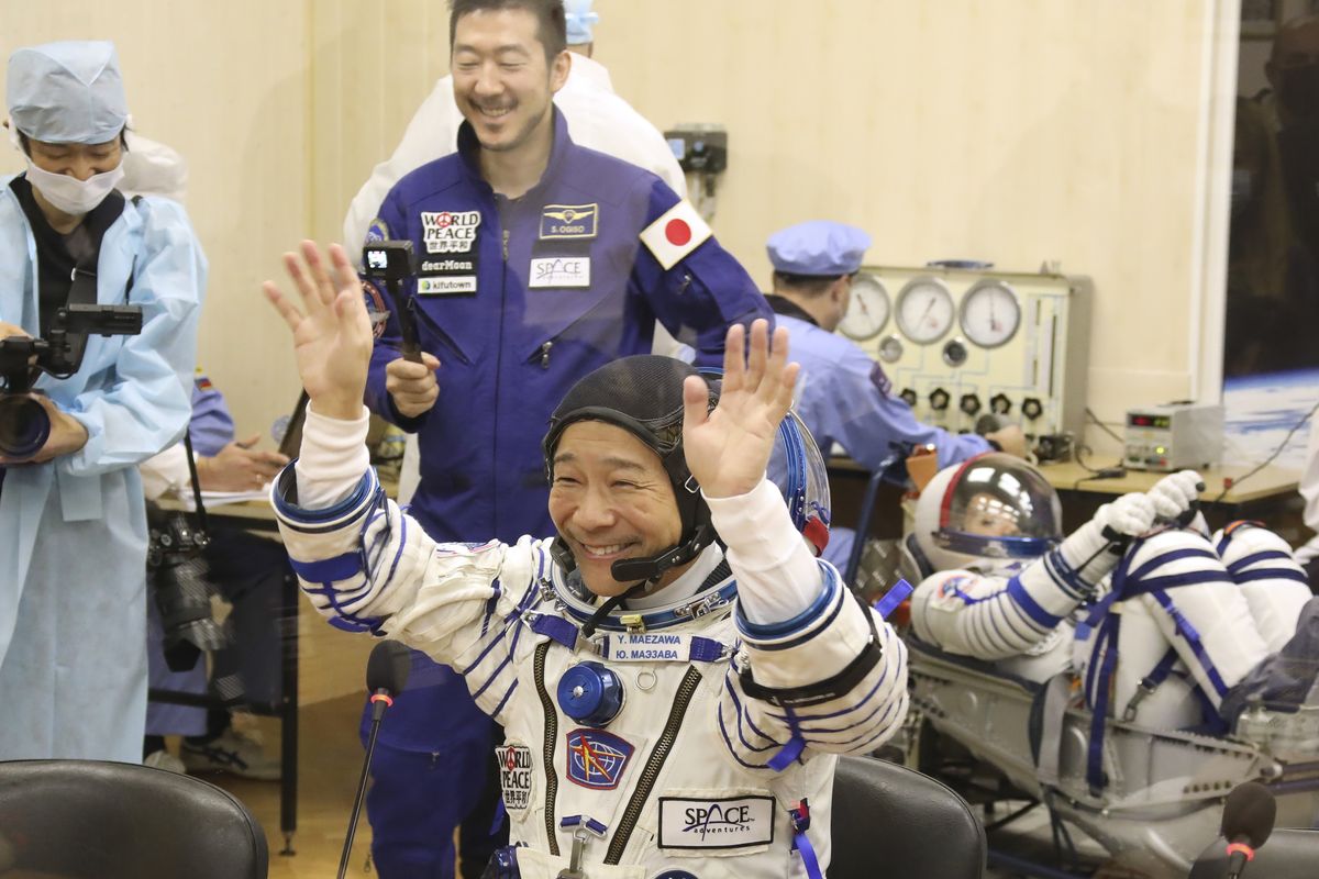 In this photo released by the Roscosmos Space Agency, spaceflight participant Yusaku Maezawa of Japan, member of the main crew of the new Soyuz mission to the International Space Station (ISS) gestures prior the launch at the Russian leased Baikonur cosmodrome, Kazakhstan, Wednesday, Dec. 8, 2021.  (Pavel Kassin)