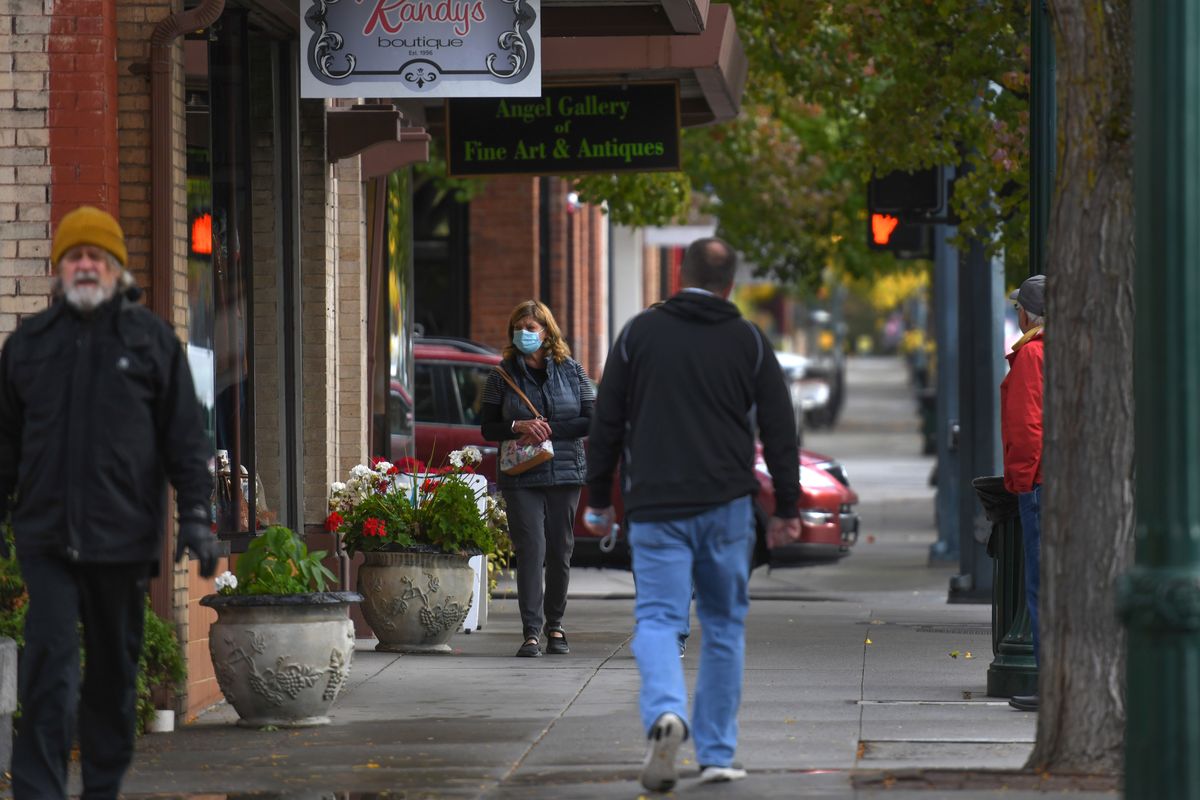 “I’m a mask supporter,” said Donna Adams, center of Mead as she walks along Sherman Avenue in Coeur d’Alene Oct. 21.   (Kathy Plonka/The Spokesman-Review)