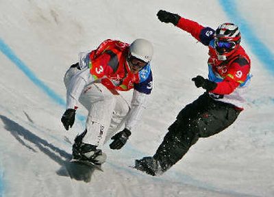 
USA's Seth Wescott, left, and Radoslav Zidek of Slovakia, maneuver at high speeds for the lead in the snowboardcross final. 
 (Associated Press / The Spokesman-Review)