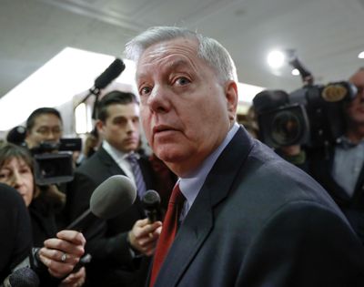 Sen. Lindsey Graham, R-S.C., speaks to reporters as he arrives at the office of Sen. Susan Collins, R-Maine, who was moderating bipartisan negotiations on immigration Jan. 25, 2018 at the Capitol in Washington. (J. Scott Applewhite / Associated Press)