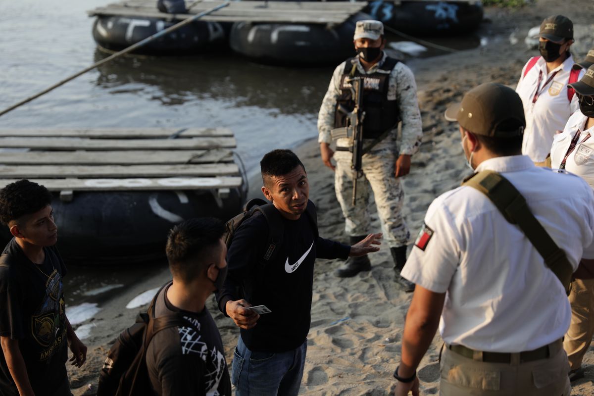 Mexican immigration agents stop people who crossed the Suchiate River, the natural border between Guatemala and Mexico, to see their identification documents as they enforce limits on all but essential travel near Ciudad Hidalgo, Mexico, Monday, March 22, 2021. Agents are forcing those with permission to enter Mexico for work or a visit to use the official border crossing bridge, and those who do not are being returned to Guatemala.  (Eduardo Verdugo)