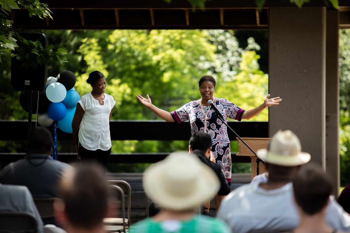 Lisa Gardner, spokesperson for the City of Spokane, left, and Betsy Wilkerson, City of Spokane councilwoman, deliver closing remarks at Praise in the Park on the Sunday of Juneteenth weekend at Liberty Park.  (Libby Kamrowski/ THE SPOKESMAN-REVIEW)