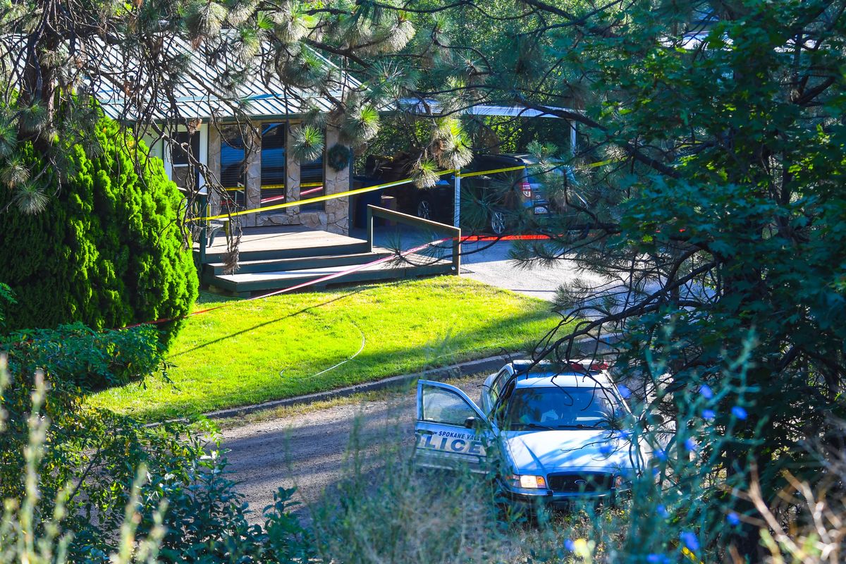 Crime tape is strung across front yards as law enforcement investigates an officer-involved shooting on Hills Court, Wednesday morning, July 25, 2018 in Spokane, Wash. (Dan Pelle / The Spokesman-Review)