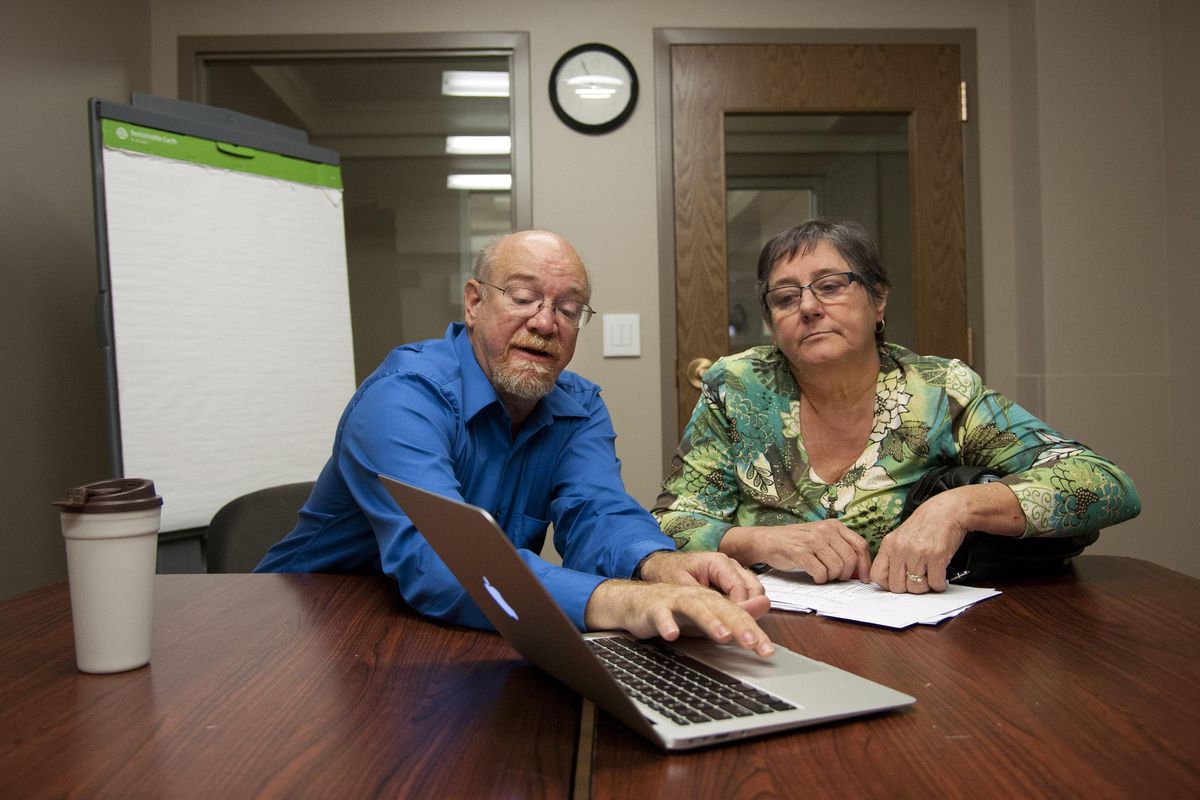 Donna Russell is shopping for new health insurance plans for her family through the state-run exchange, Washington Health Benefit Exchange. Her husband’s employer recently dropped insurance coverage for its workers. Helping her find the right plan is Curt Fackler, an exchange navigator with Better Health Together. (Dan Pelle / The Spokesman-Review)