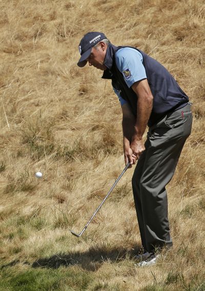 Matt Kuchar hits from rough on the 18th hole during a practice round for the U.S. Open golf tournament at Chambers Bay on Wednesday. (Associated Press)