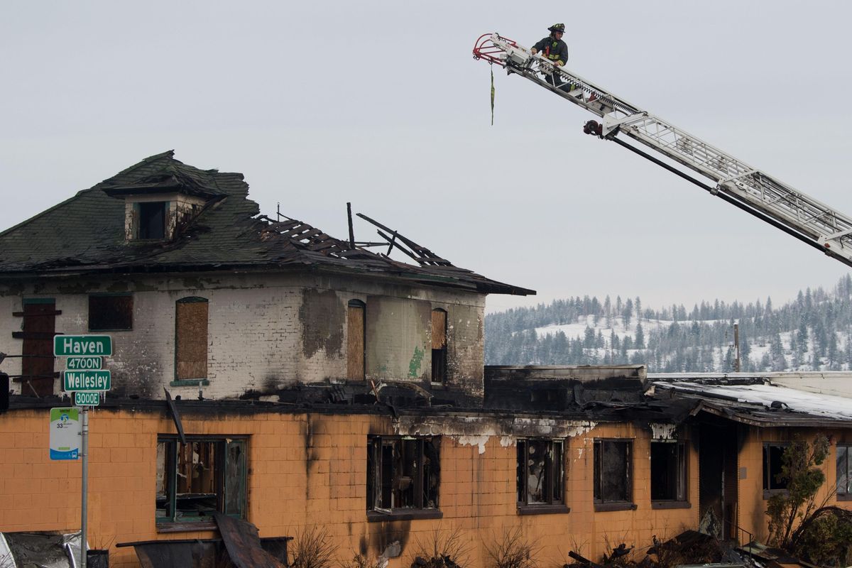 Crews investigate a fire in an abandoned former nursing home and rehabilitation center in Hillyard on Tuesday. (Tyler Tjomsland / The Spokesman-Review)