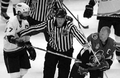 A referee breaks up Anaheim's Scott Niedermayer and Ottawa's Daniel Alfredsson in Game 4.
 (Associated Press / The Spokesman-Review)