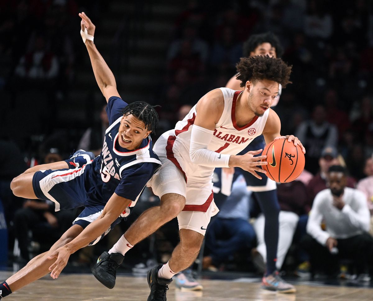 Gonzaga guard Rasir Bolton (45) stumbles as Alabama guard Mark Sears (1) grabs control of the ball during the first half of a NCAA college basketball game, Saturday, Dec.17, 2022, in Birmingham, Alabama.  (Colin Mulvany / The Spokesman-Review)