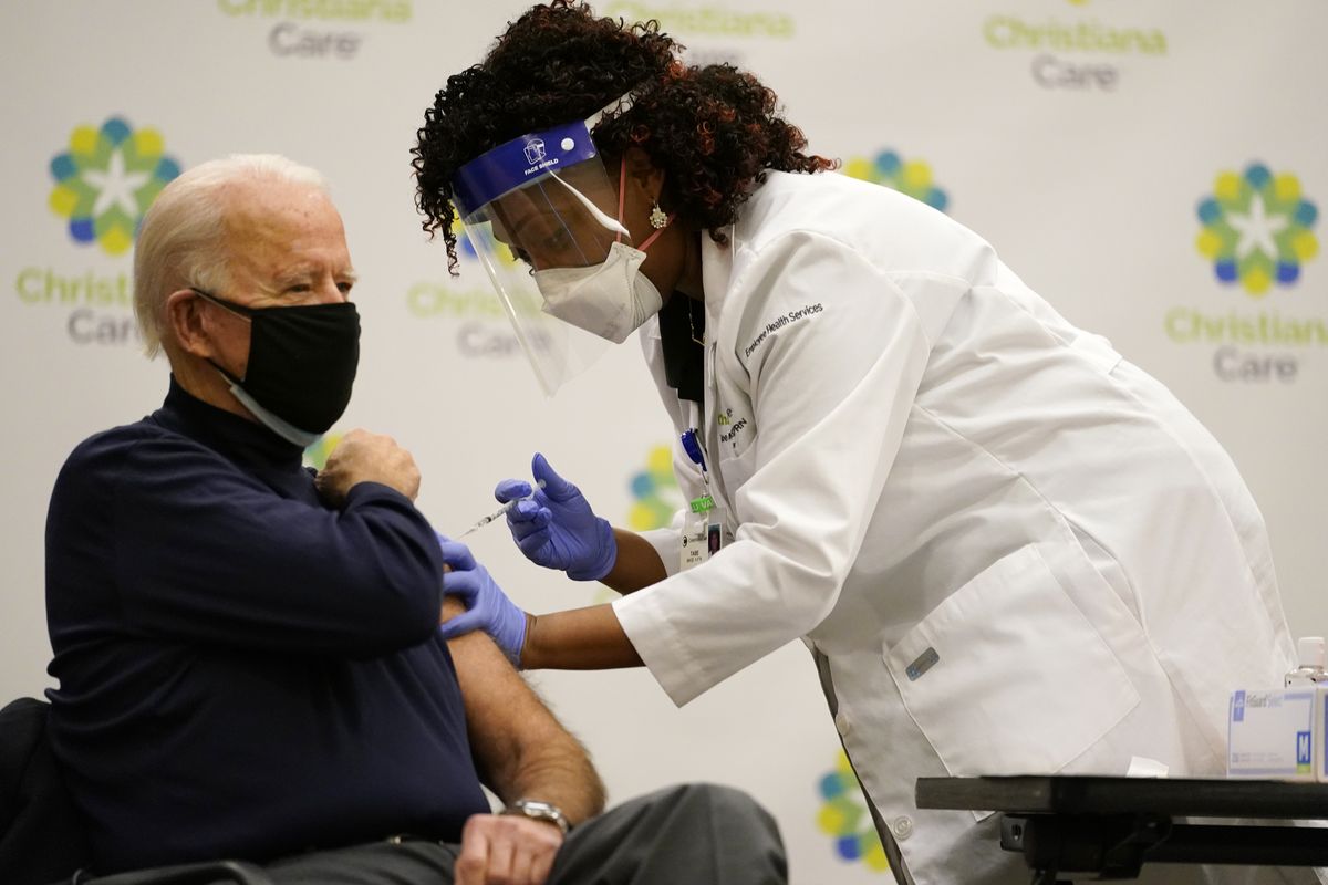 President-elect Joe Biden receives his first dose of the coronavirus vaccine at ChristianaCare Christiana Hospital in Newark, Del., Monday, Dec. 21, 2020, from nurse practitioner Tabe Mase.  (Carolyn Kaster)