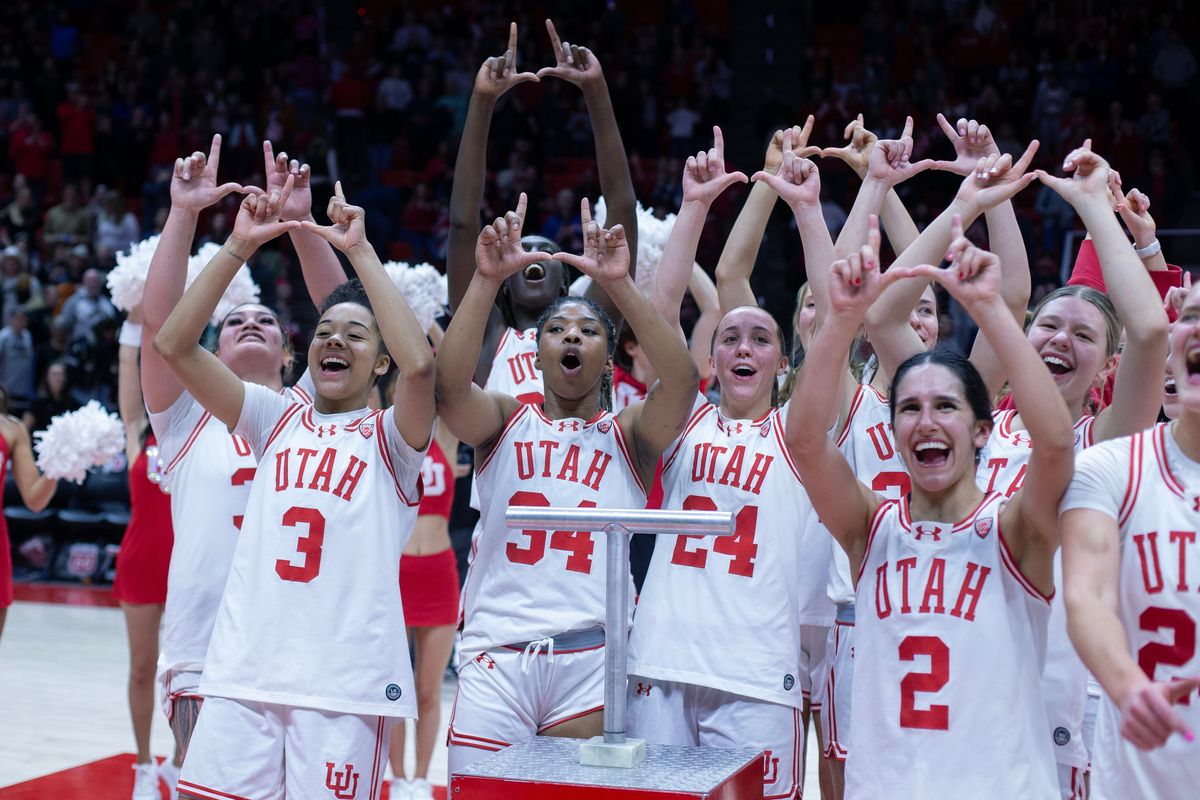SALT LAKE CITY, UT - FEBRUARY 16: Alissa Pili #35, Lani White #3, Dasia Young #34, Kennady McQueen #24, Inez Vieira #2, Reese Ross #20, and Nene Sow #25 of the Utah Utes celebrate their upset win over the Colorado Buffaloes at the Jon M Huntsman Center on Feb. 16 in Salt Lake City. The Utah team faced racist taunts when they traveled a month later to Coeur d