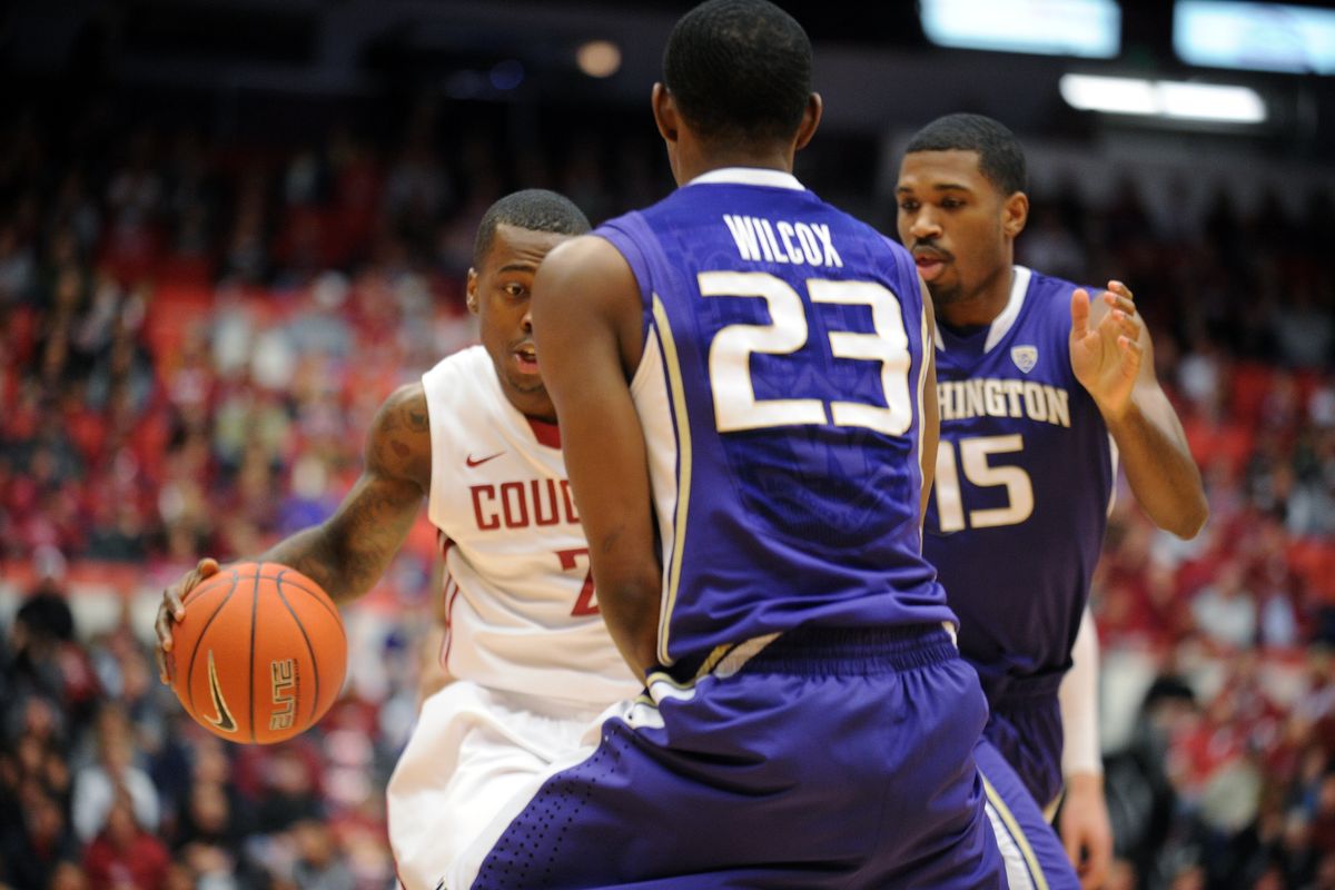 WSU guard Mike Ladd drives the ball against Washington guard C.J. Wilcox (23). (Tyler Tjomsland)