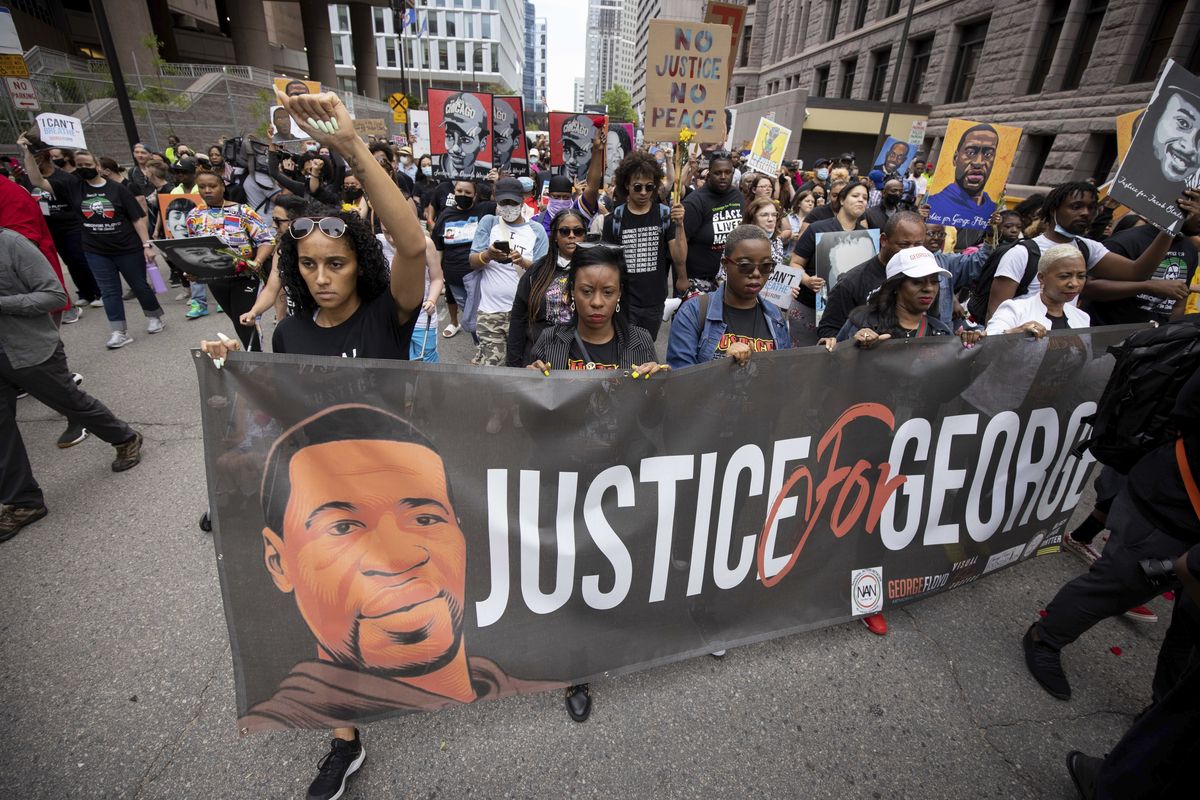People march for the one-year anniversary of George Floyd’s death on Sunday in Minneapolis.  (Christian Monterrosa)