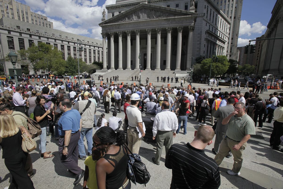 People stand in Foley Square in New York after being evacuated from the federal and state buildings that surround it Tuesday, Aug. 23, 2011. A 5.9-magnitude earthquake centered northwest of Richmond, Va., shook much of Washington, D.C., and was felt as far north as Rhode Island and New York City. (Richard Drew / Associated Press)