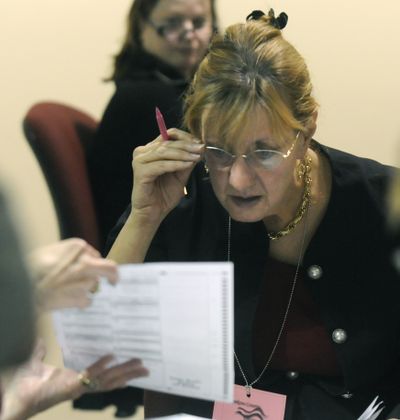 Cindy Zapotocky, a Republican Party election observer, gets a close view of a ballot’s precinct number while she was watching the recount of the 6th Legislative District race between John Ahern and John Driscoll, December 2, 2008 at the Spokane County Elections Office. Driscoll eventually won the race.  (DAN PELLE)