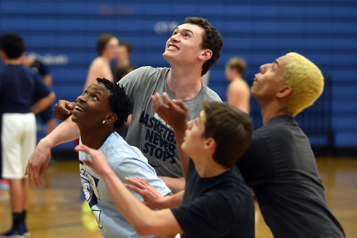 Ryan Rehkow, top, the only returning starter from Central Valley High School’s state championship basketball team, battles teammates, clockwise from left, Michael Plunkitt, Kobe King, and Jason Butler. (Jesse Tinsley / The Spokesman-Review)