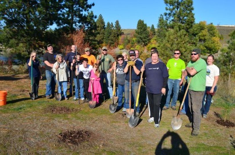 Some of the 64 volunteers who helped in October with a shoreline restoration project at the Spokane River access site at the state line. (Spokane River Forum)