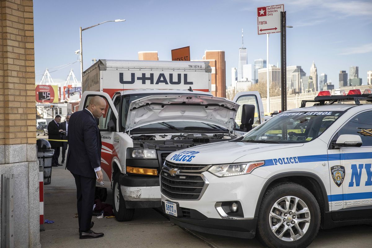 Police examine a U-Haul rental truck after the driver was arrested in New York on Monday. At least eight people were injured when a man drove a U-Haul box truck erratically through the Bay Ridge section of Brooklyn on Monday, careening onto sidewalks and hitting pedestrians, the authorities said.  (DAVE SANDERS)