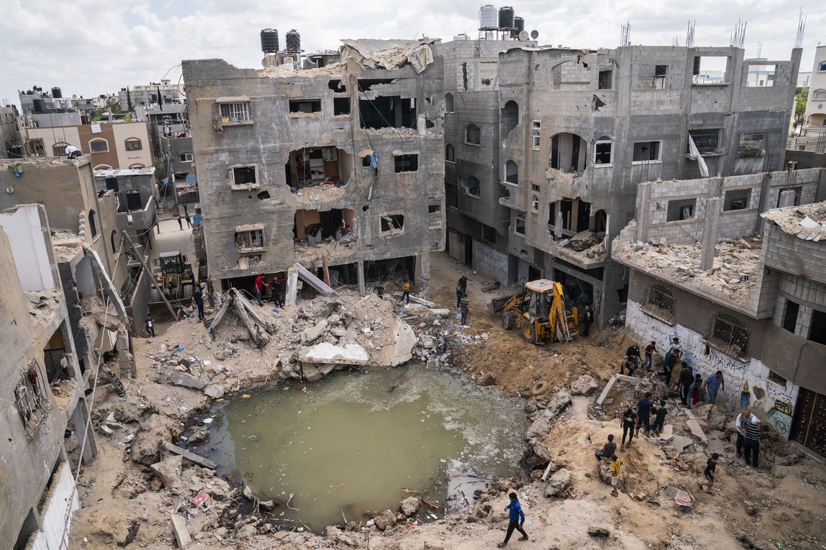 A crater full of water and sewage remains on Sunday where the home of Ramez al-Masri was destroyed by an air-strike in Beit Hanoun, the northern Gaza Strip, prior to a cease-fire reached after an 11-day war between Gaza’s Hamas rulers and Israel.  (John Minchillo)