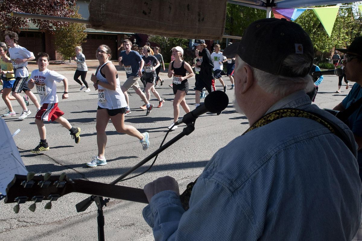 Terry Lewis, left, and Junior Lacuesta of the band JUTE play for runners during Bloomsday on Sunday, May 7, 2017, in Spokane. (Kathy Plonka / The Spokesman-Review)