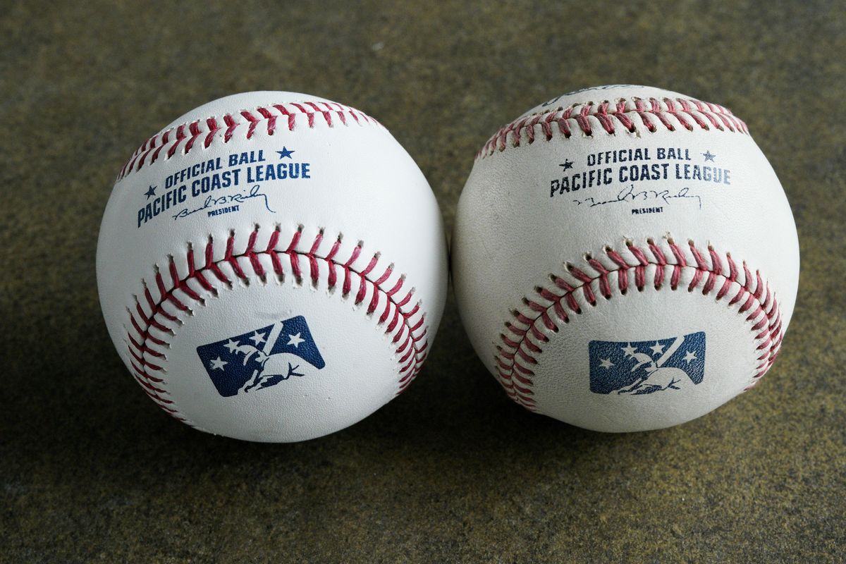 FILE - In this May 7, 2019, file photo, a new official Pacific Coast League baseball, left, is seen beside a baseball from the previous year in Papillion, Neb. Major League Baseball has reorganized its minor leagues in a 120-team regional alignment, MLB announced, Friday, Feb. 12, 2021. The leagues have not yet been named and Major league owners, Commissioner Rob Manfred and his staff have not decided whether to retain the traditional names of the leagues, such as Pacific Coast League.  (Nati Harnik)