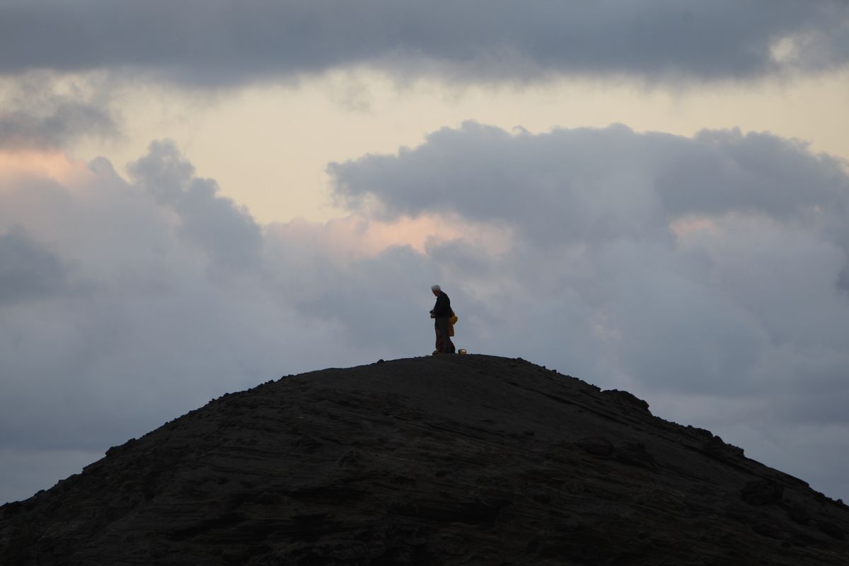 Above: A man watches as Yasur volcano erupts. The Vanuatu volcano has become a popular tourist attraction. (Associated Press)