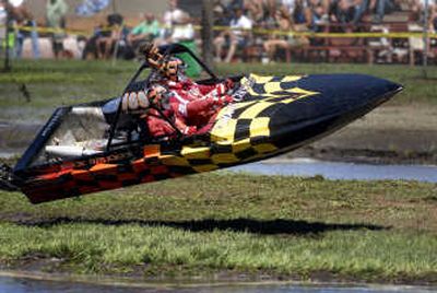 
Jack Bright and navigator Jack Bright Jr. take an unplanned flight during qualification at the Webs Slough sprint boat race Saturday. 
 (Jed Conklin / The Spokesman-Review)