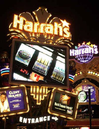 
Harrah's casino entrance is shown in Las Vegas. Harrah's Entertainment has agreed to buy Caesars Entertainment for more than $5 billion in a deal that would create the world's largest gambling company.
 (Associated Press / The Spokesman-Review)