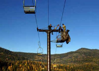 
49 Degrees North employees Larry Stephensen, left, Robert Haden and Duane Reese (in red) prepare the No. 3 lift last week at the ski resort north of Chewelah.
 (Jed Conklin / The Spokesman-Review)