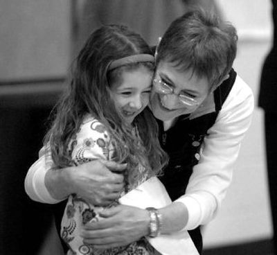 
Teacher Kathy Montgomery hugs Brooklyn Cunningham after it was announced that Montgomery received the School Champion of the Month award based on Cunningham's nomination at Skyway Elementary.  
 (Jesse Tinsley / The Spokesman-Review)