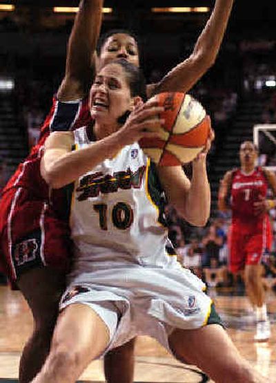 Seattle's Sue Bird drives to the basket as Houston's Kedra Holland-Corn defends during second-half play.
 (Associated Press / The Spokesman-Review)