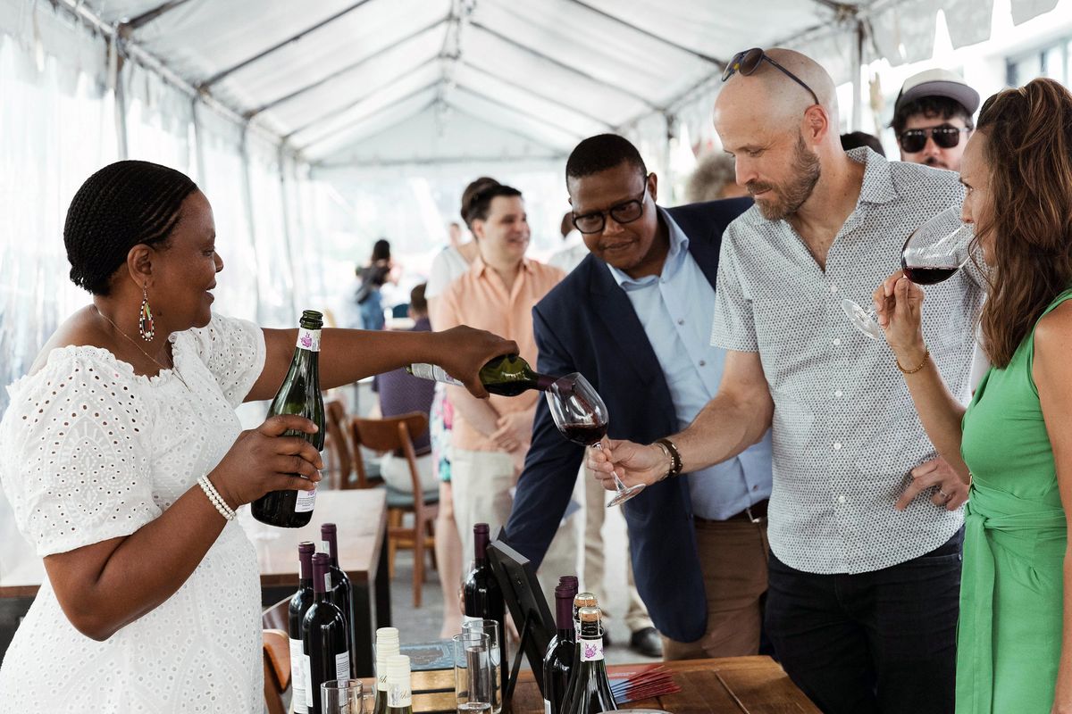 Winemaker Nondumiso Pikashe, left, of Ses’fikile Wines, pours a South African red wine for guests at the Go There Wines Launch Party at Maydan in Washington, D.C.  (Maya Oren/Handout)
