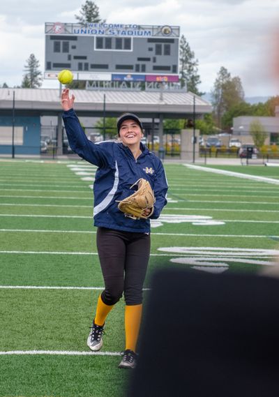 Mead junior catcher Bella Brischle warms up before practice on Tuesday at Union Stadium in Mead. (Madison McCord/For The Spokesman-Review)