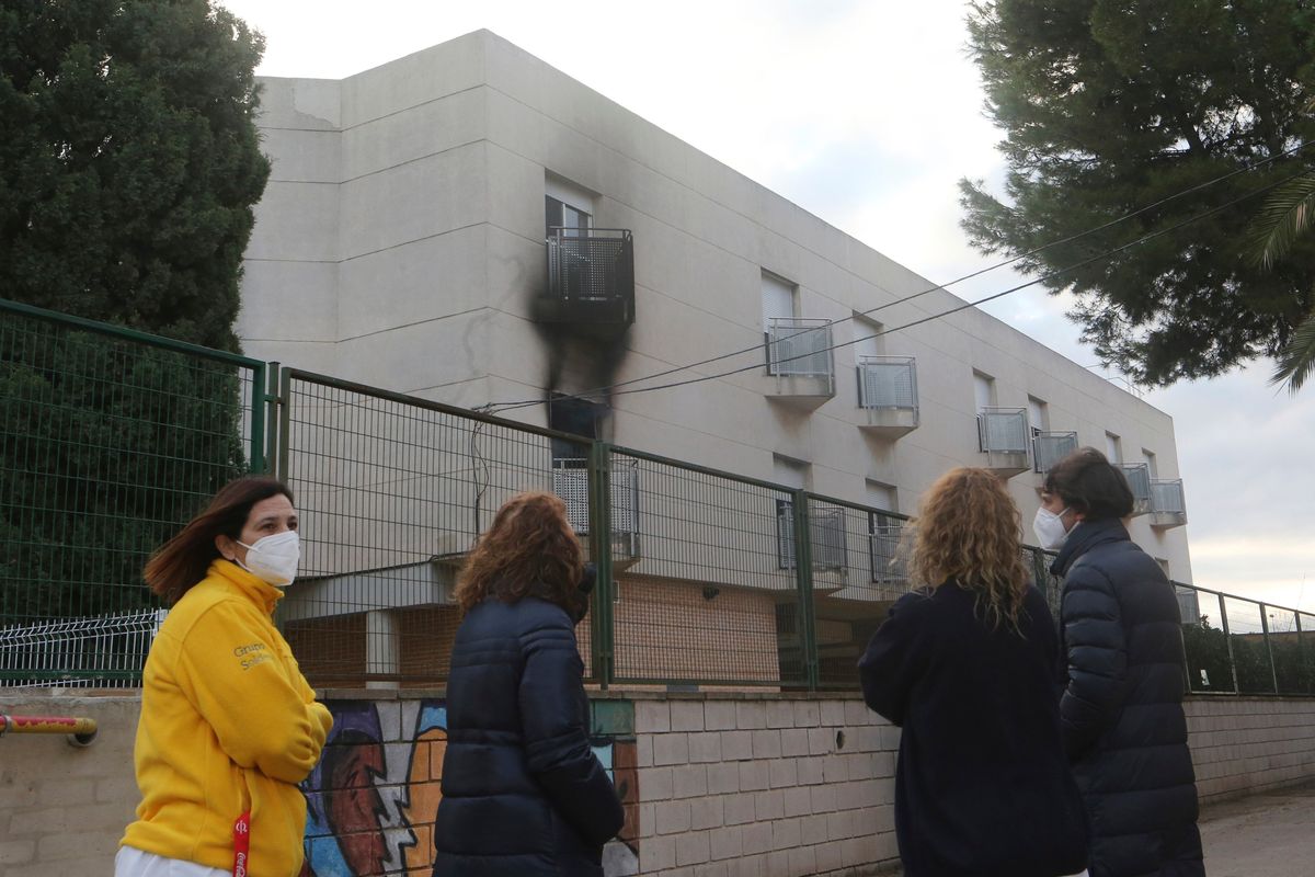 People look towards a nursing home after a fire in the municipality of Moncada on Wednesday just north of Valencia, Spain.  (Alberto Saiz)