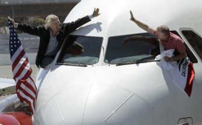 
Virgin Group Chairman Richard Branson, left, tries to high-five CEO of Virgin America Fred Reid, after arriving from New York on a Virgin America flight at San Francisco International Airport on Wednesday. Associated Press
 (Associated Press / The Spokesman-Review)