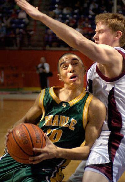 
Shadle's Leo Avila is fouled by North Central's Nathan Hood. 
 (Christopher Anderson / The Spokesman-Review)