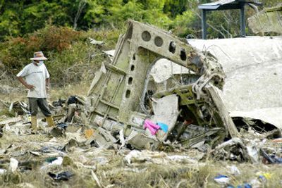
A rescue worker surveys the wreckage of a Colombian airplane Tuesday after it crashed west of Caracas, Venezuela. 
 (Associated Press / The Spokesman-Review)