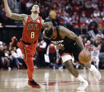 Rockets guard James Harden drives past Hawks guard Damion Lee Sunday in Houston. (Eric Christian Smith / Associated Press)