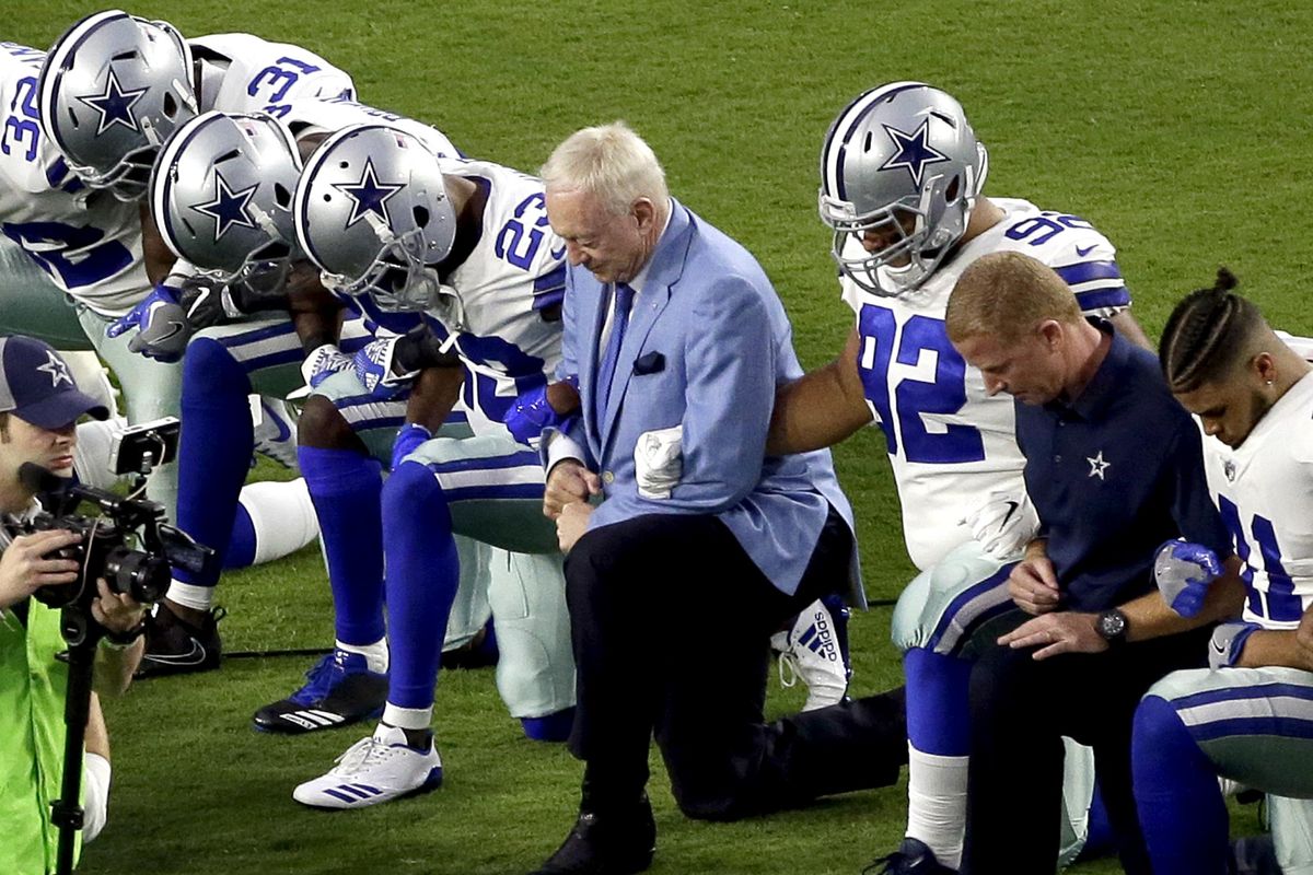 The Dallas Cowboys, led by owner Jerry Jones, center, take a knee prior to the national anthem prior to an NFL football game against the Arizona Cardinals, Monday, Sept. 25, 2017, in Glendale, Ariz. (Matt York / Associated Press)