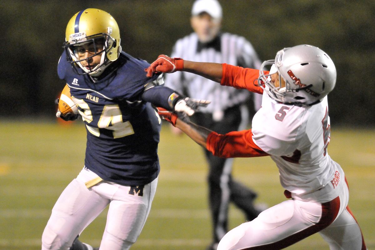 Mead running back Davian Barlow, left, repels Ferris’ Isaiah Troutt. It was Barlow’s first game in four weeks after an injury. (Jesse Tinsley)