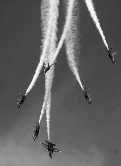 The Navy Blue Angels perform the last maneuver before No. 6, the plane just above center, crashed during an air show at Marine Corps Air Station Beaufort in South Carolina on Saturday. 
 (Associated Press / The Spokesman-Review)