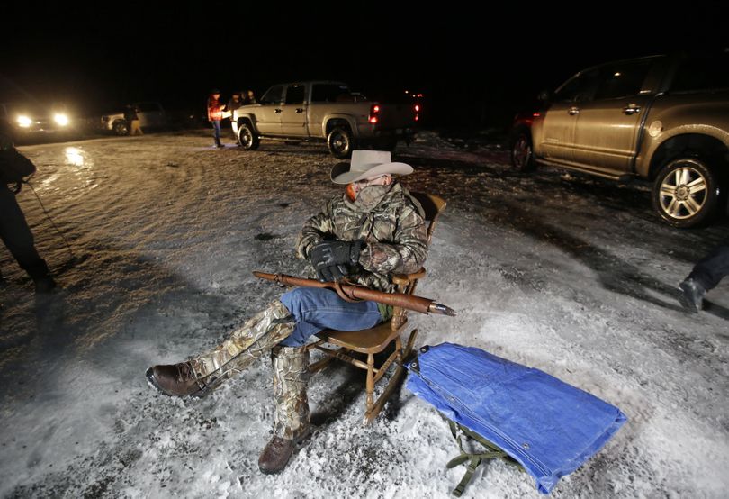 Arizona rancher LaVoy Finicum holds a rifle as he guards the Malheur National Wildlife Refuge on Tuesday near Burns, Ore.