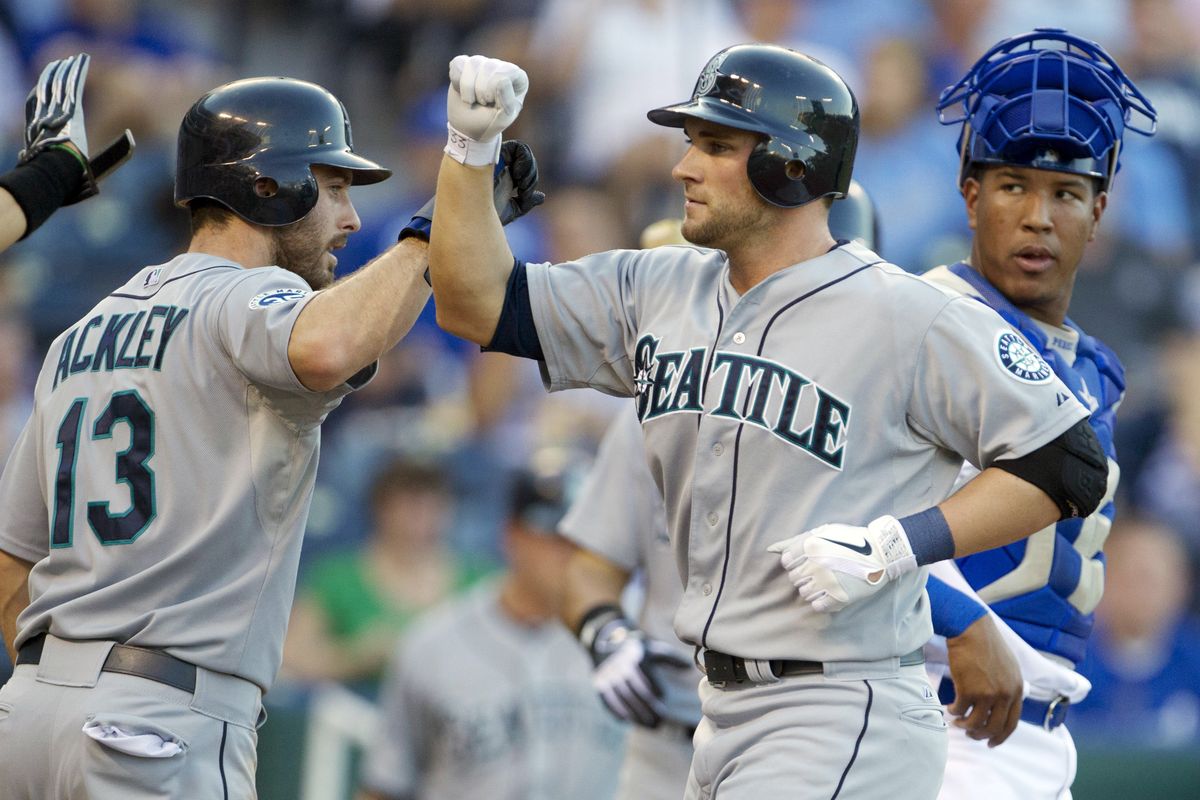 Seattle’s Casper Wells celebrates his three-run home run in the first inning with Dustin Ackley, who walked to lead off the game. (Associated Press)