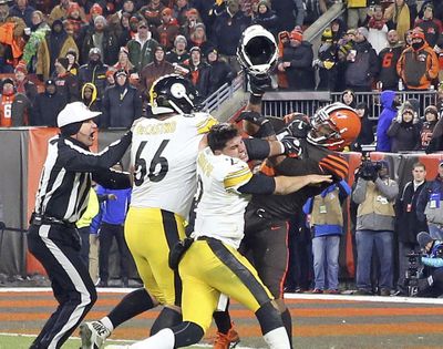 Cleveland Browns defensive end Myles Garrett (95) hits Pittsburgh Steelers quarterback Mason Rudolph (2) with a helmet during the second half of an NFL football game Thursday, Nov. 14, 2019, in Cleveland. (Joshua Gunter, cleveland.com / Associated Press)