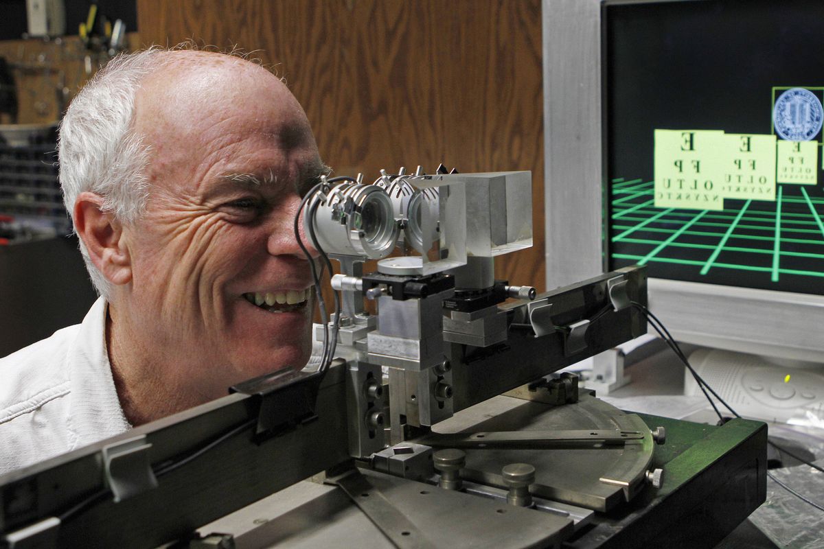 University of California at Berkeley professor Martin Banks looks through a birefringent lens display –  a desk-bound contraption  with lenses that accomodate the eyes’ natural inclination to focus at different distances. He says the setup reduces eyestrain and mental fatigue from 3-D images, though it may not eliminate them entirely.  (Associated Press)
