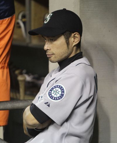Ichiro Suzuki watches from the dugout during the ninth inning Friday. (Associated Press)