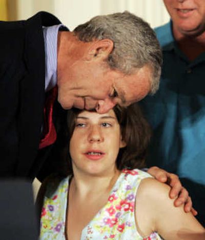 
President Bush hugs Kaitlyne McNamara, of Middletown, Conn., who has spina bifida. Associated Press
 (Associated Press / The Spokesman-Review)